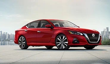 2023 Nissan Altima in red with city in background illustrating last year's 2022 model in Gunn Nissan in San Antonio TX